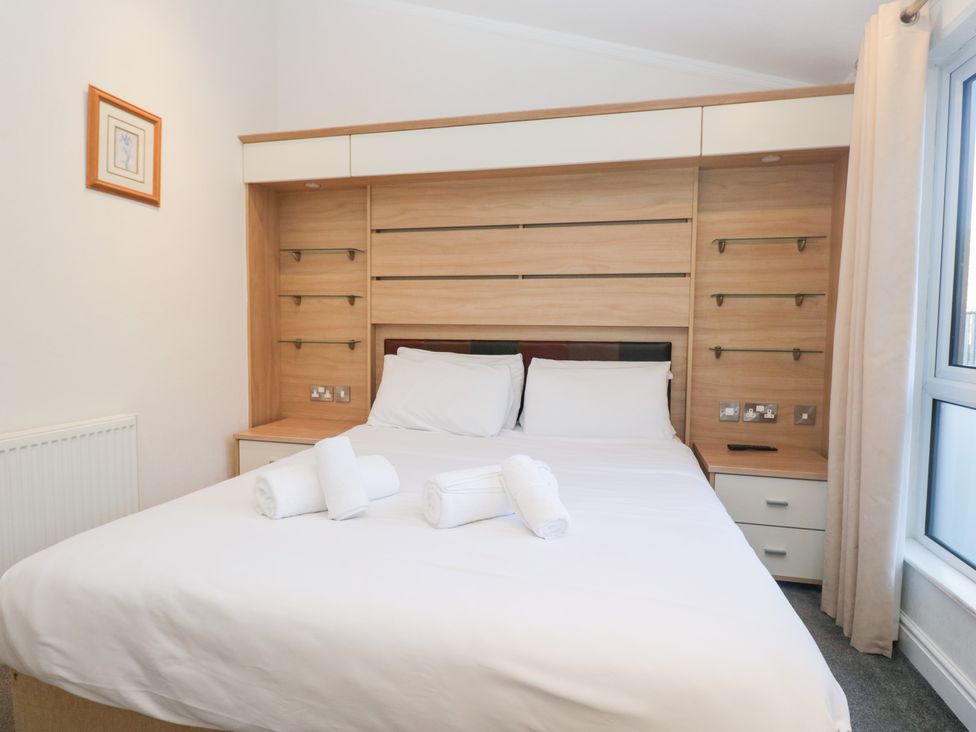 A bedroom with a bed and shelves at Heights View in 