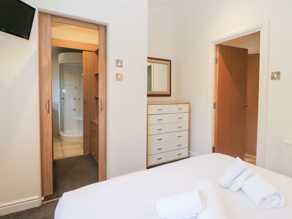 A bedroom with a dresser and shower area at Heights View