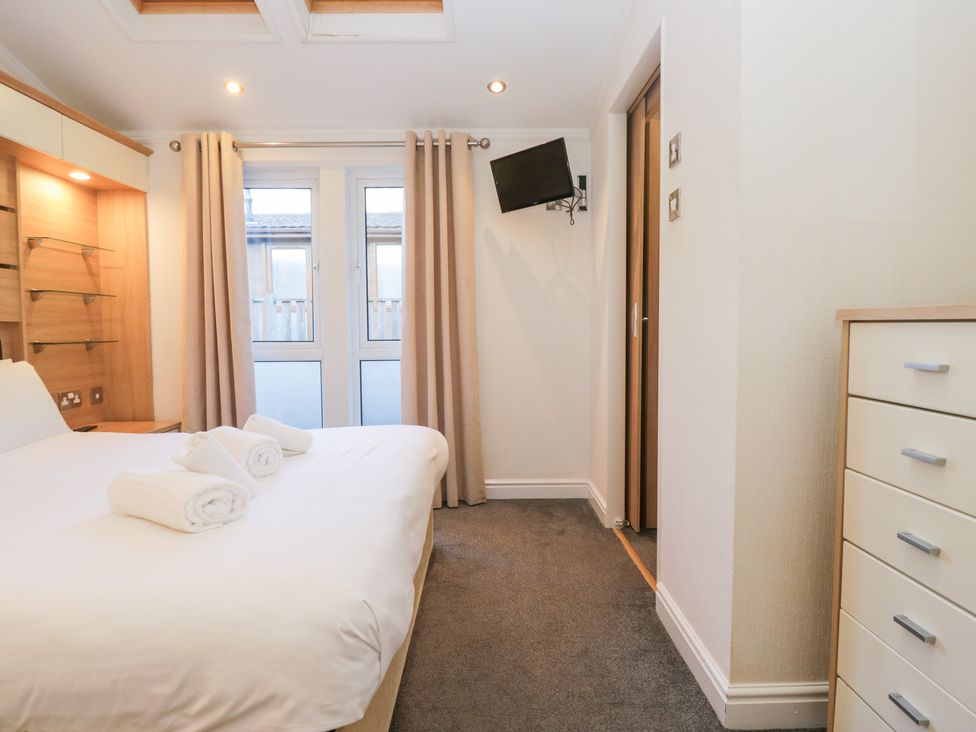 A bedroom with a bed and towels on top at Heights View 