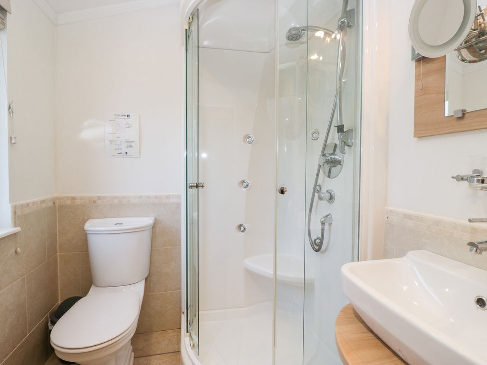 A bathroom featuring a shower, toilet, and sink at Heights View