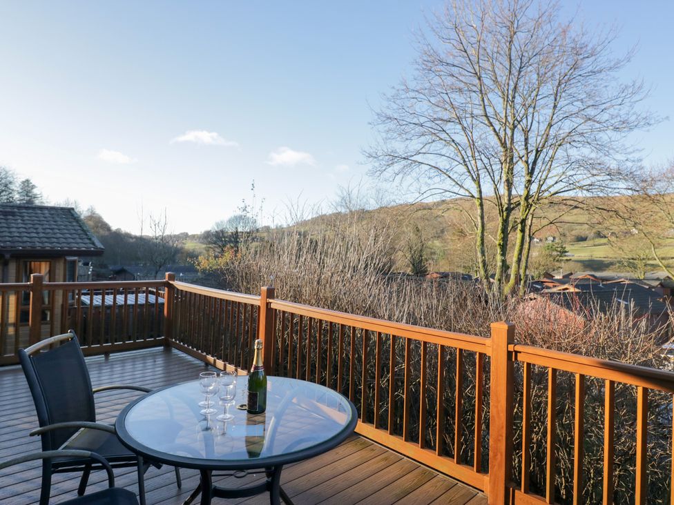 An outdoor deck with a table and chairs at Heights View