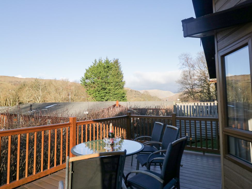 An outdoor deck with a table and chairs at Heights View in 