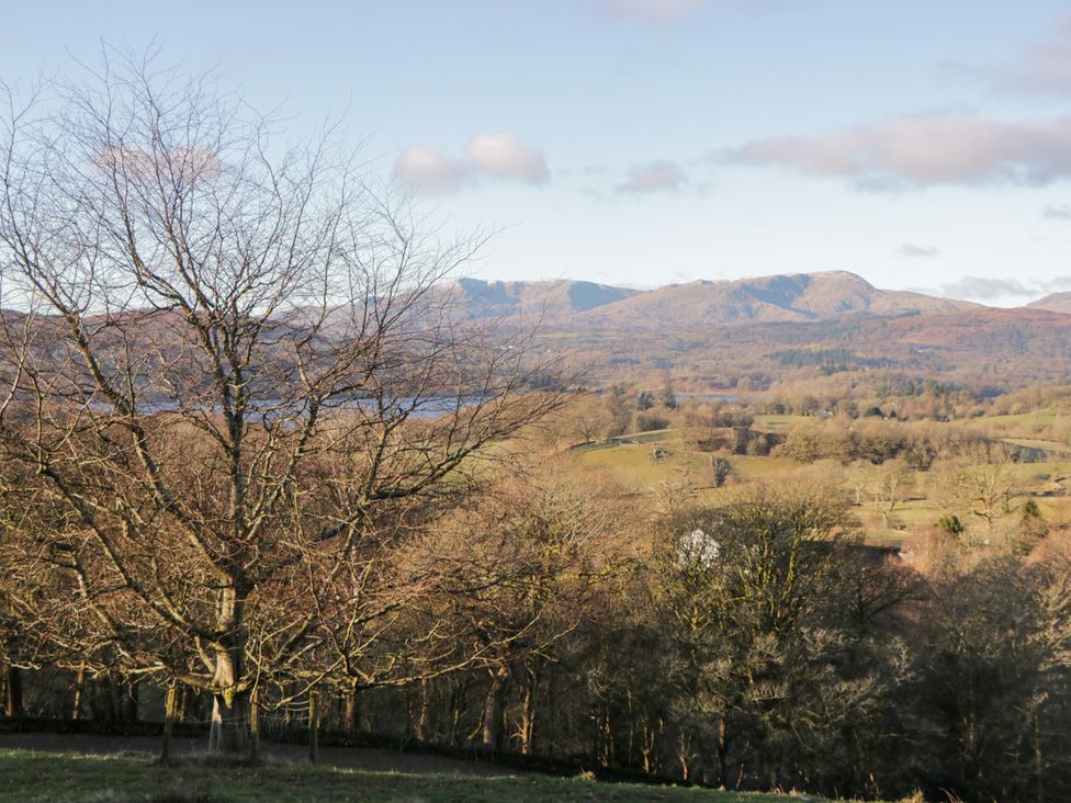 A view of mountains and a tree near a body of water at Heights View