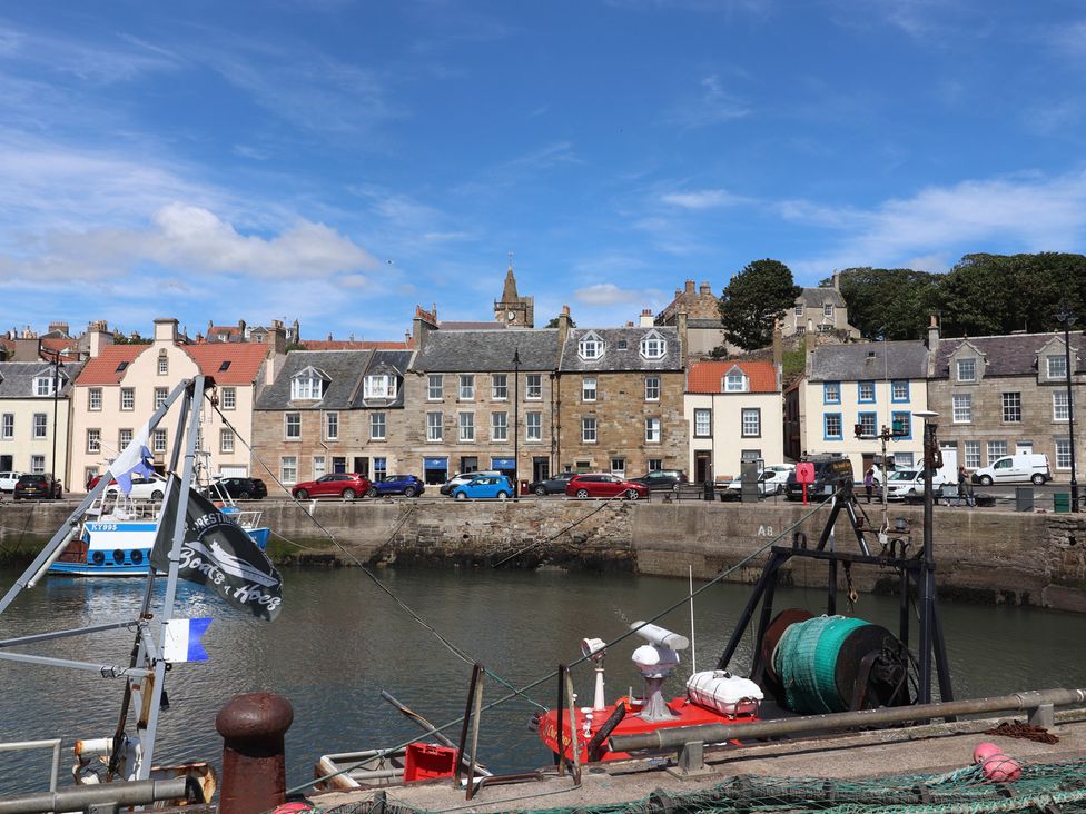 A harbor with boats and buildings at Maimie’s Harbourview in Pittenweem near Anstruther