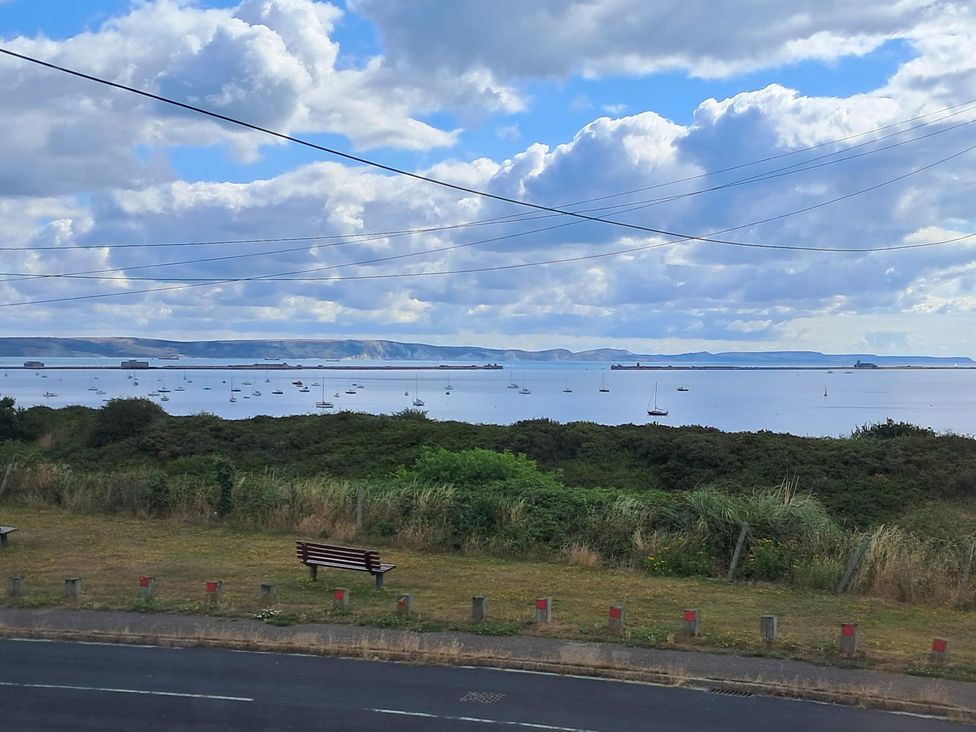 A view of water with boats and clouds at The Lookout -The House With A View in Weymouth