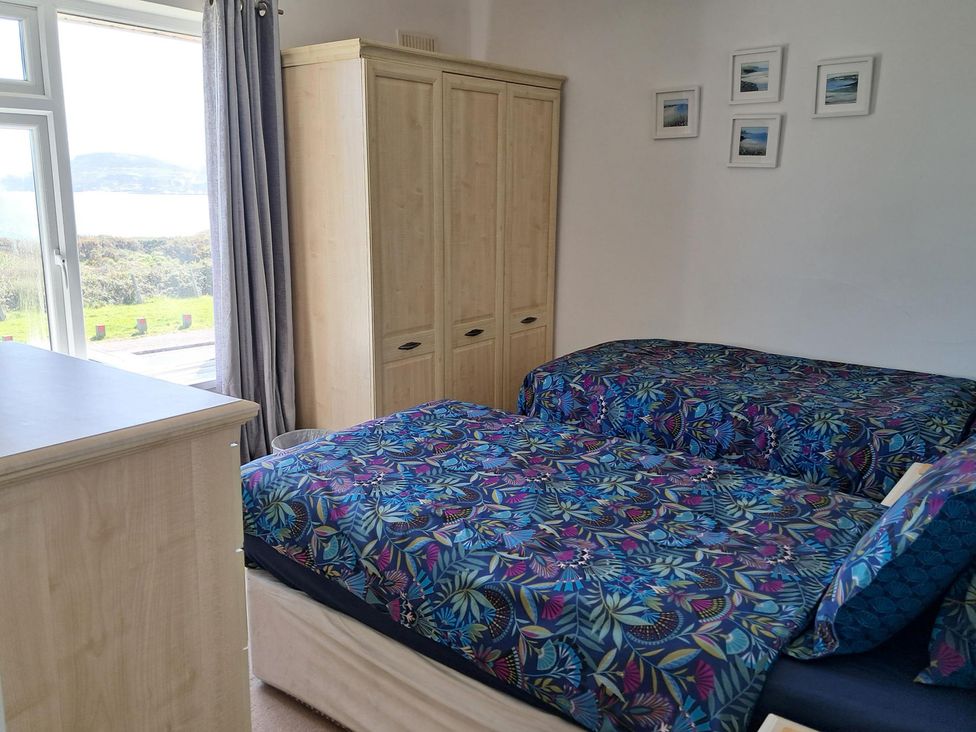 A bedroom with two beds and a wardrobe at The Lookout -The House With A View in Weymouth