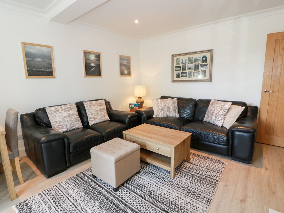 A living room with sofas and a coffee table at Simply Suite in Castle Douglas