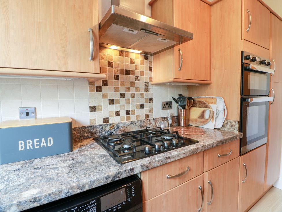 A kitchen with a cooker and a bread bin at Simply Suite in Castle Douglas