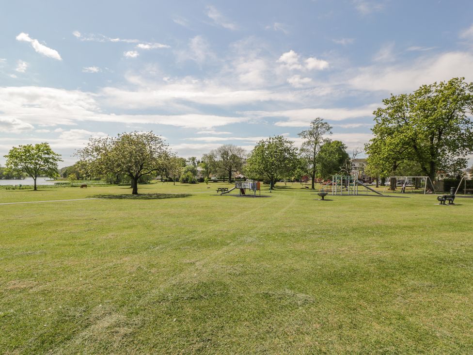 A park with playground equipment and benches at Simply Suite in Castle Douglas