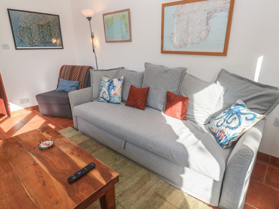 A living room with a sofa and armchair at Kernyk in Penzance