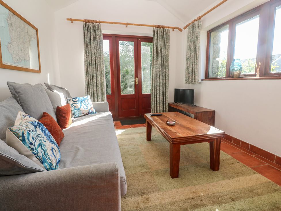 A living room with a sofa and coffee table at Kernyk in Penzance
