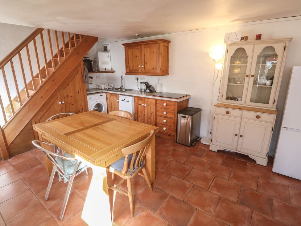 A kitchen with a table and chairs at Kernyk in Penzance