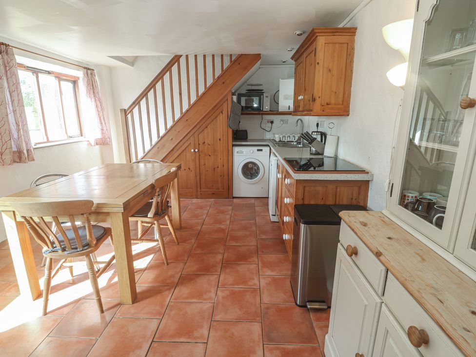 A kitchen with a table and chairs at Kernyk in Penzance