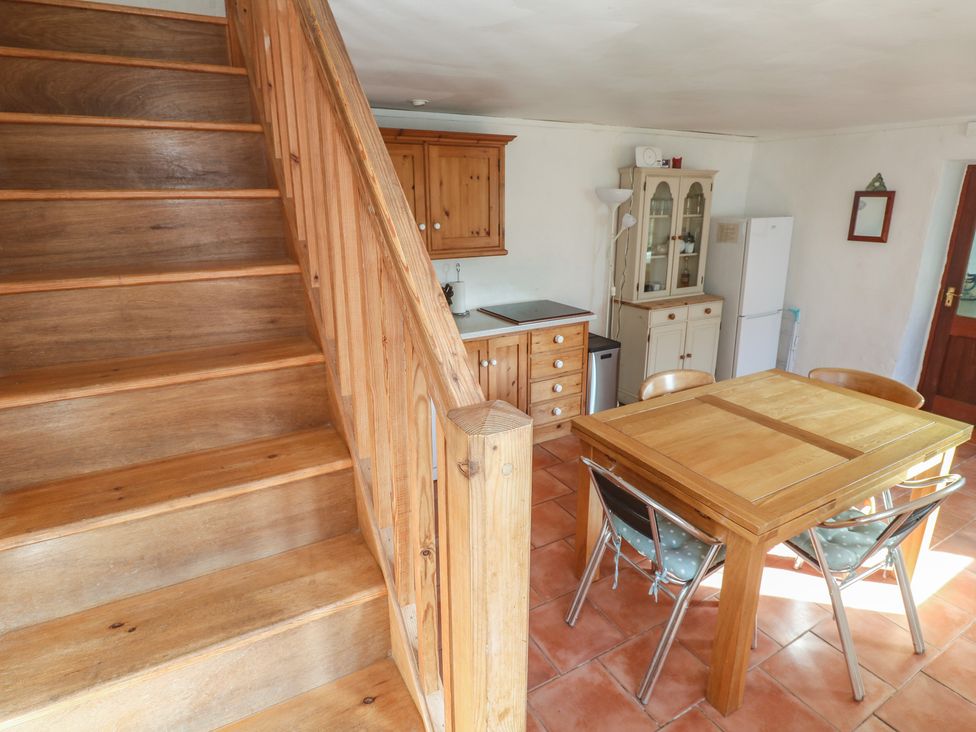 A kitchen with a dining table and chairs at Kernyk in Penzance