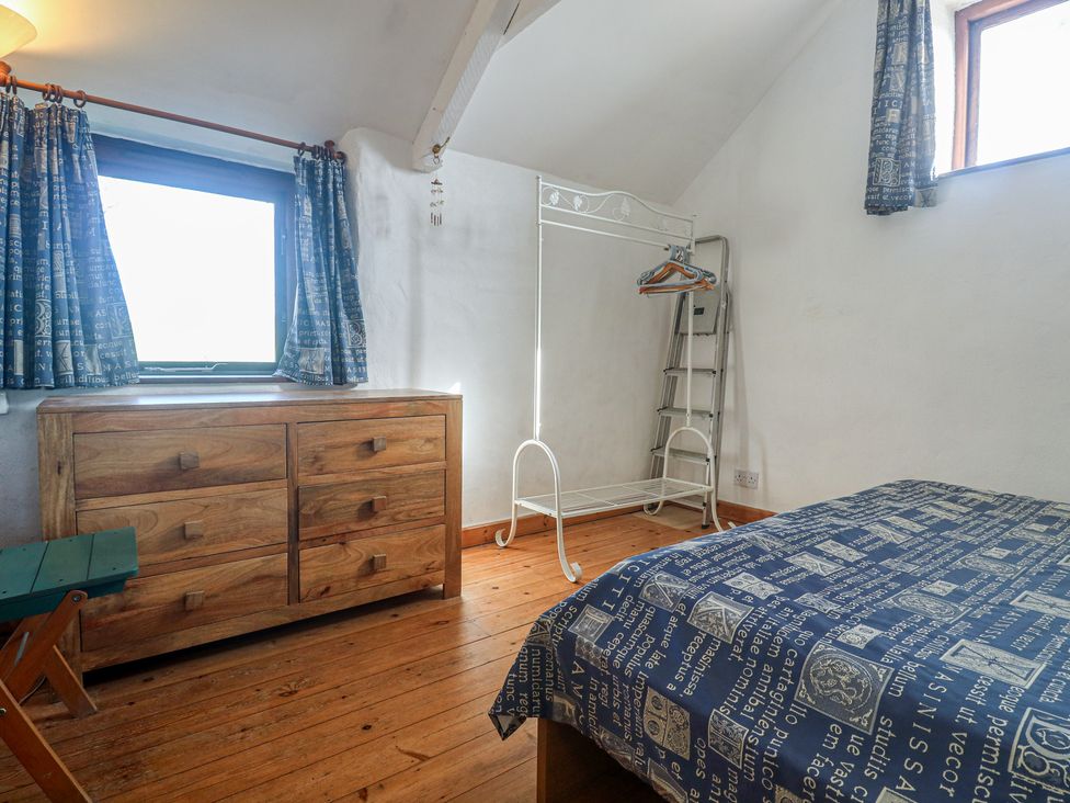 A bedroom with a bed and dresser at Kernyk in Penzance