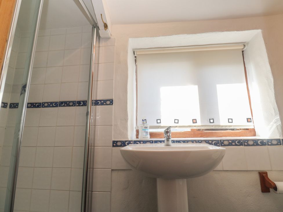 A bathroom with a shower and a sink at Kernyk in Penzance