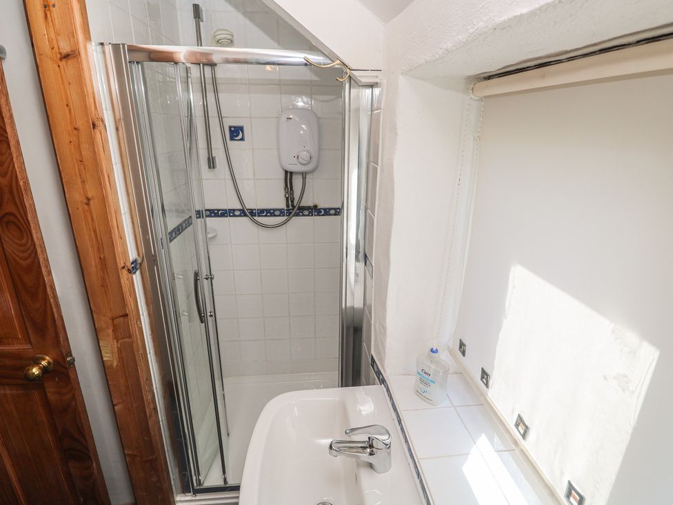 A bathroom with a shower and sink at Kernyk in Penzance