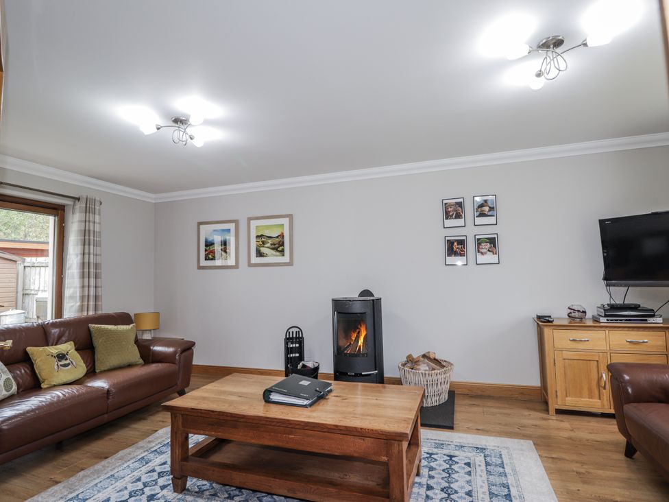 A living room with a sofa and coffee table at Burnside House in Aviemore
