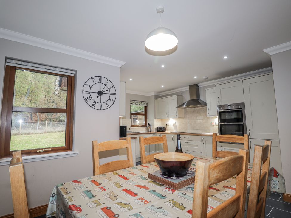 A kitchen with a table and chairs at Burnside House in Aviemore