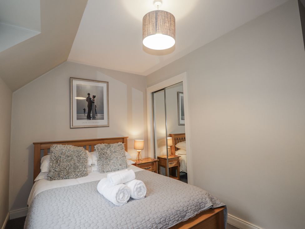 A bedroom with a bed and lamp at Burnside House in Aviemore
