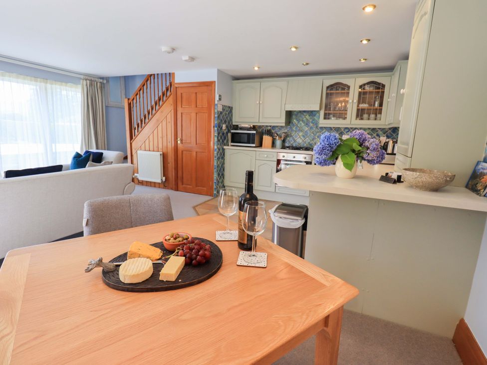 A kitchen with a dining area featuring a cheese platter at Lakeside Cottage in Ecclerigg near Ambleside