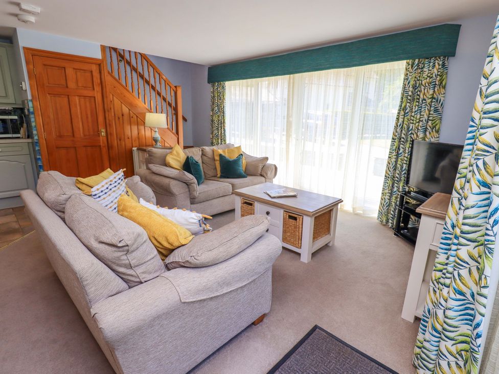 A living room with sofas and a coffee table at Waterhead Cottage in Ecclerigg, near Troutbeck Bridge