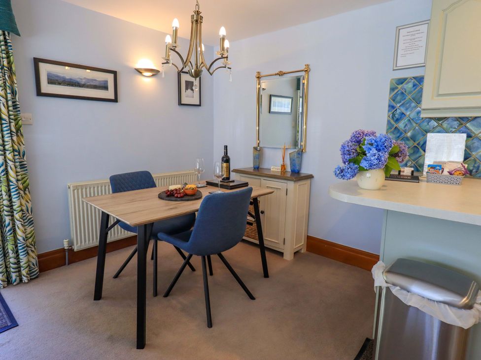 A dining room with a table and chairs at Waterhead Cottage, Ecclerigg, near Troutbeck Bridge