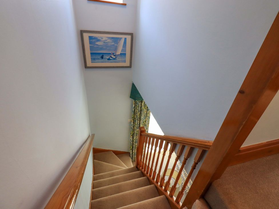 A staircase with a painting and curtain at Waterhead Cottage, Ecclerigg, near Troutbeck Bridge