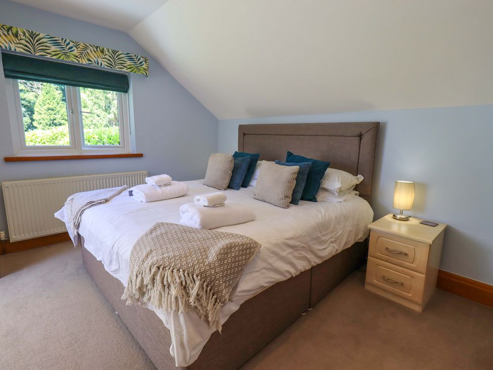 A bedroom with a bed and lamp at Waterhead Cottage in Ecclerigg, near Troutbeck Bridge