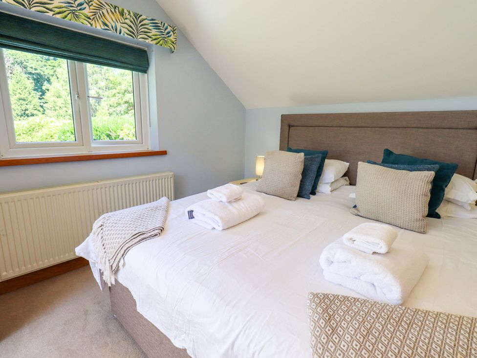A bedroom with a bed and two pillows at Waterhead Cottage in Ecclerigg, near Troutbeck Bridge