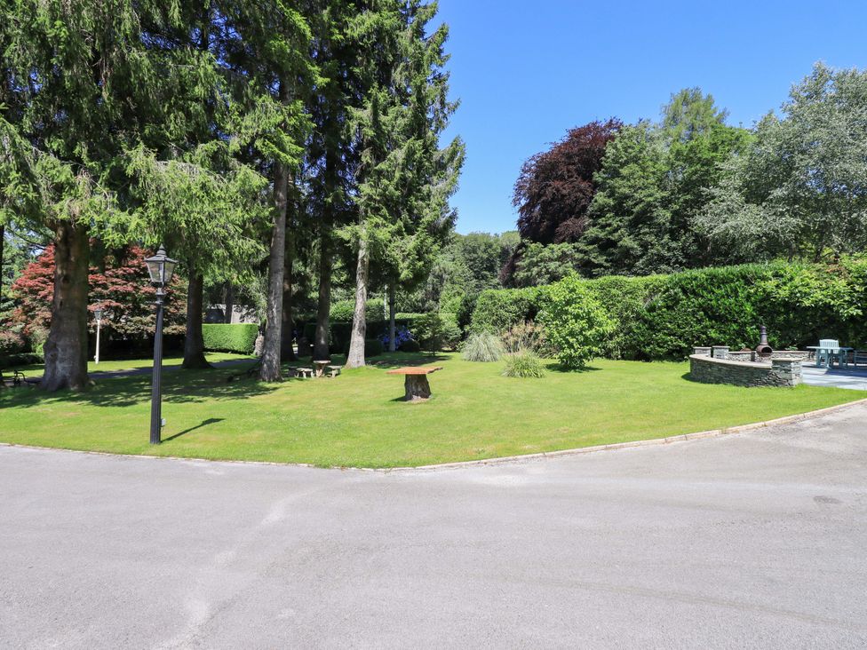 A garden with trees and grass at Waterhead Cottage, Ecclerigg, near Troutbeck Bridge