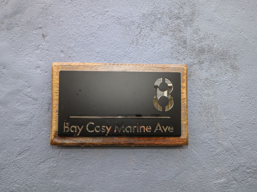 A name plate displaying Bay Cosy Marine Ave at Bay Cosy in Pevensey Bay