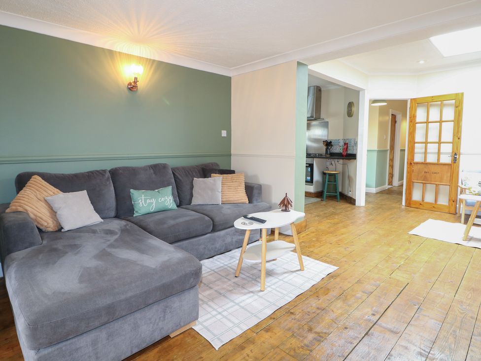 A living room with a sofa and table at Bay Cosy in Pevensey Bay