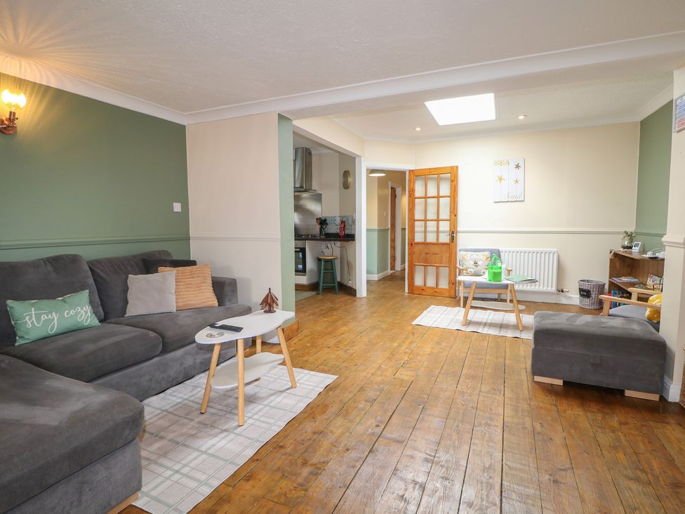 A living room with a sofa and coffee table at Bay Cosy Pevensey Bay