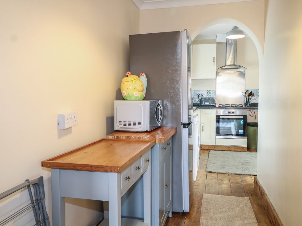 A kitchen with a refrigerator and microwave at Bay Cosy in Pevensey Bay