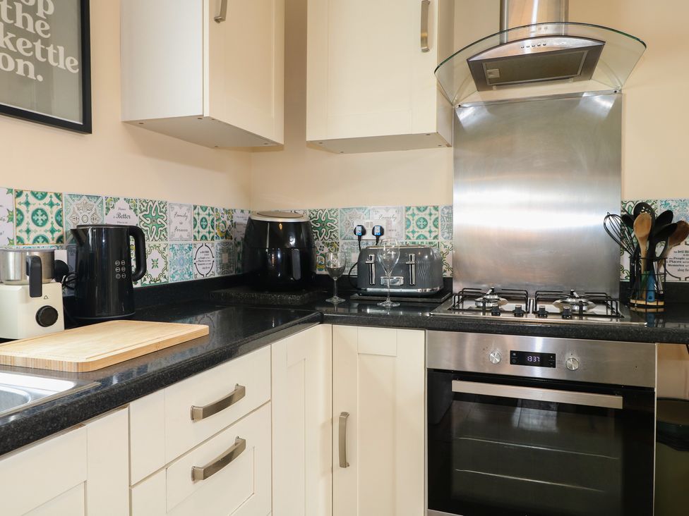 A kitchen with appliances on the counter at Bay Cosy, Pevensey Bay