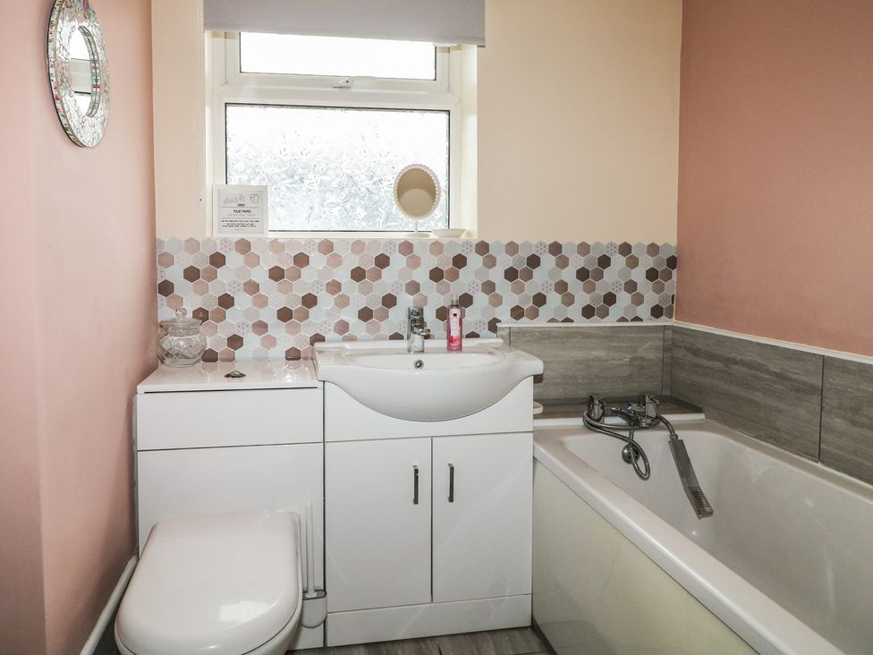 A bathroom with a sink and bathtub at Bay Cosy in Pevensey Bay