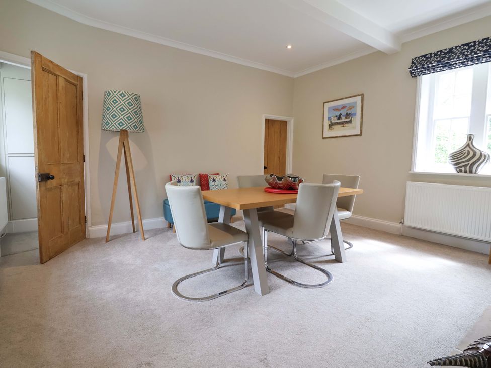 A dining room featuring a table and chairs at South Tower Cottage in Capesthorne near Macclesfield