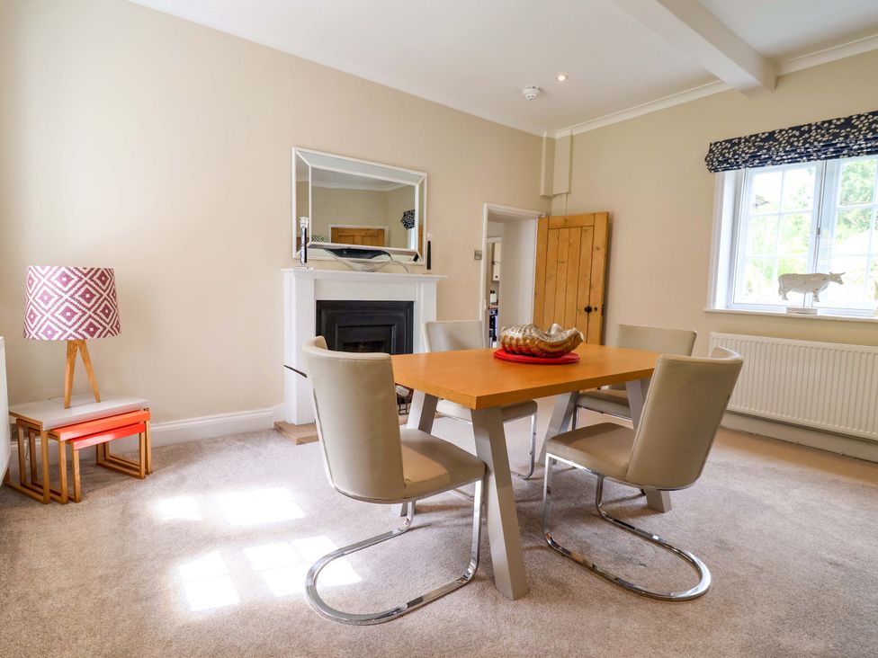 A dining room with a table and chairs at South Tower Cottage Capesthorne near Macclesfield