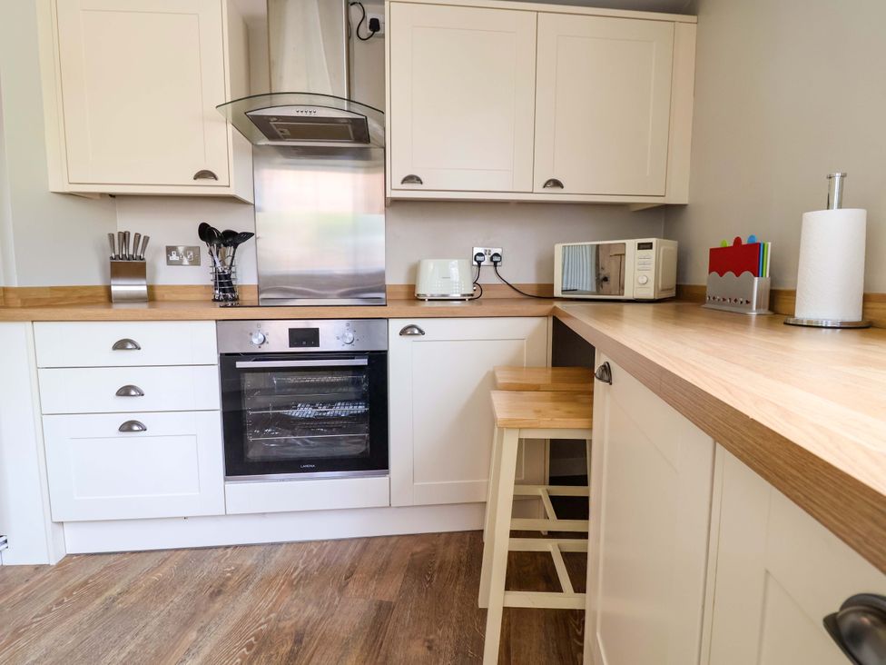 A kitchen with an oven and microwave at South Tower Cottage Capesthorne near Macclesfield