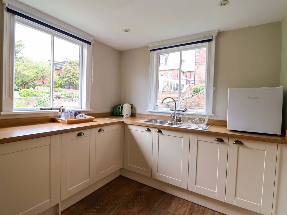 A kitchen with a sink and mini fridge at South Tower Cottage in Capesthorne near Macclesfield