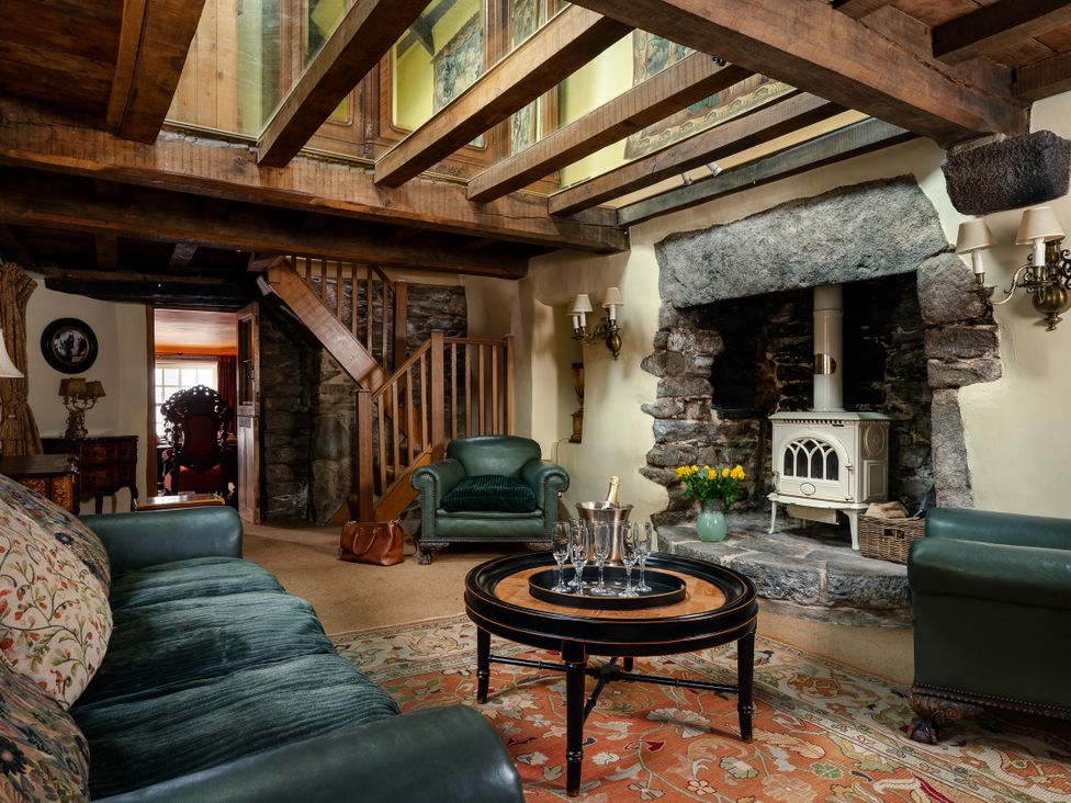 A living room with a sofa, armchair, and coffee table at The Meeting House in Ashburton