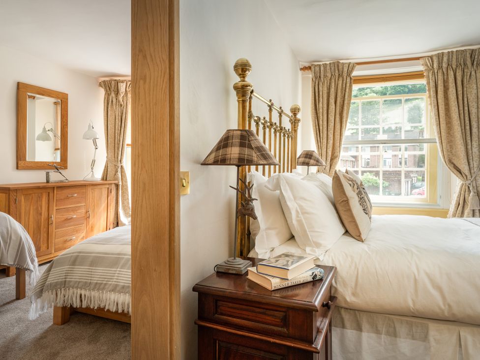 A bedroom with two beds and a dresser at The Meeting House in Ashburton