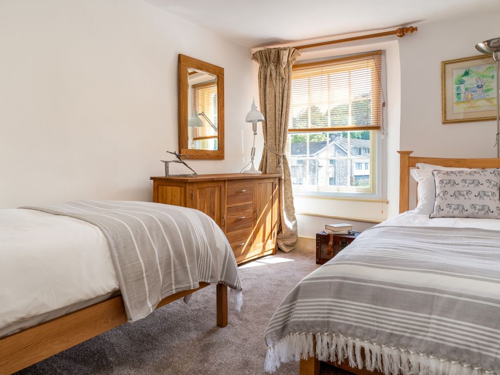 A bedroom with two beds and a dresser at The Meeting House in Ashburton