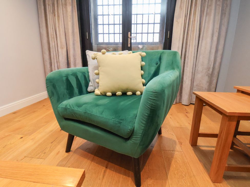 A chair with cushions in a living room at Premier, Transit & Lady Hilda @ Engine Shed, Whitby
