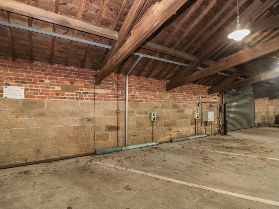 A garage with brick walls and concrete floor at Premier, Transit & Lady Hilda @ Engine Shed, Whitby