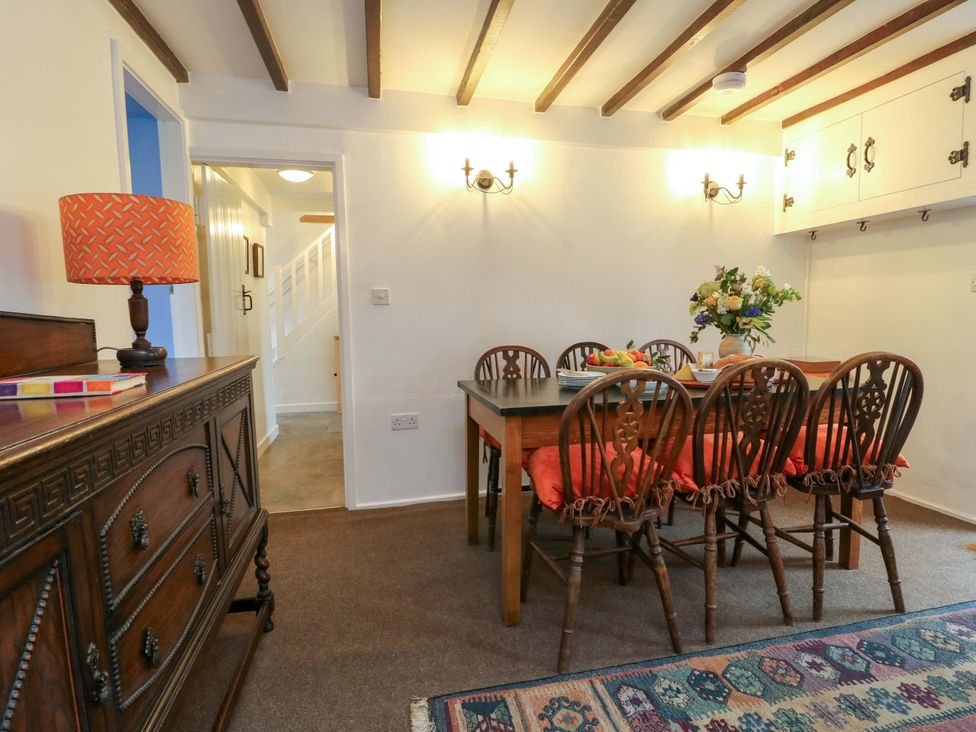 A dining room with table and chairs at Ael Y Bryn in Menai Bridge