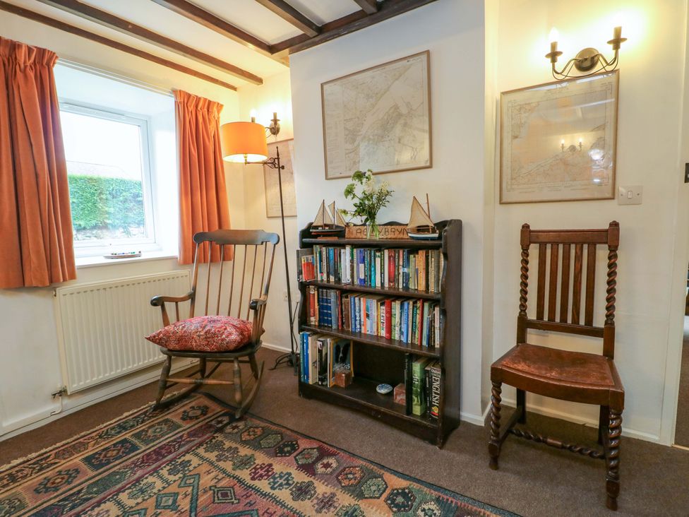 A snug with a rocking chair and bookshelf at Ael Y Bryn Menai Bridge