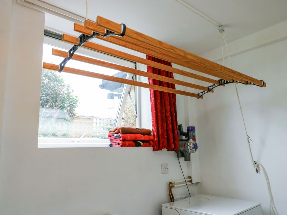A laundry room with a drying rack and towels at Ael Y Bryn Menai Bridge