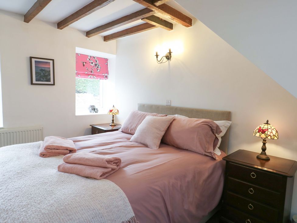 A bedroom with a bed and nightstand at Ael Y Bryn in Menai Bridge